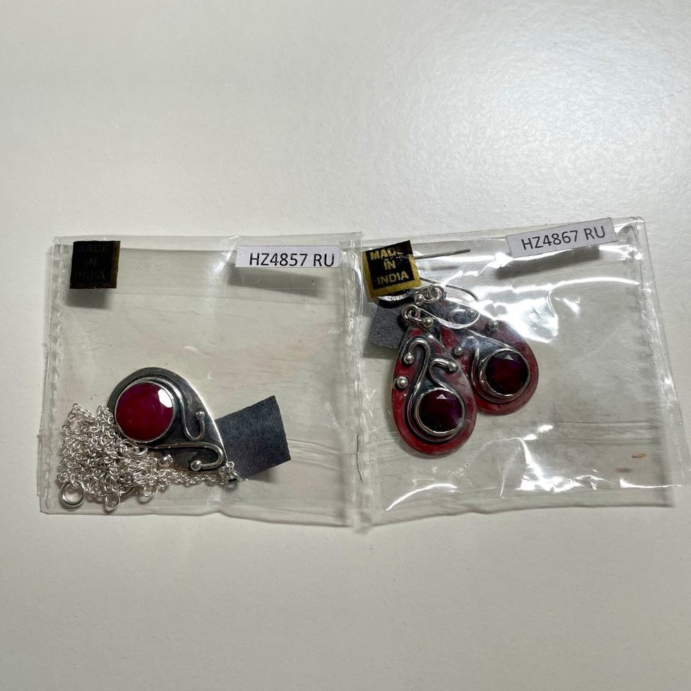 Silver earrings and necklace with berry red stones